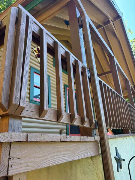 Close-up of a refinished wood deck railing and balusters