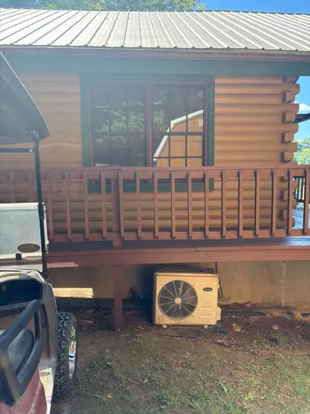 Porch railing and window trim stained on a log cabin